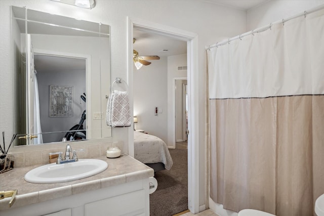bathroom featuring visible vents, curtained shower, a ceiling fan, connected bathroom, and vanity