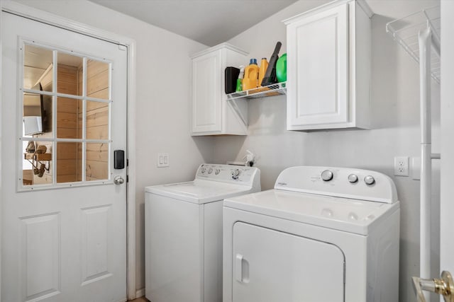 laundry area with washer and dryer and cabinet space