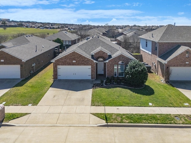 traditional-style house with a residential view, a garage, concrete driveway, and a front lawn