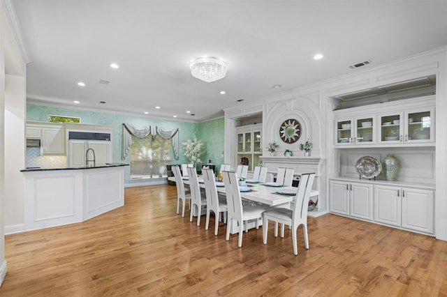 dining room with recessed lighting, visible vents, ornamental molding, and light wood finished floors