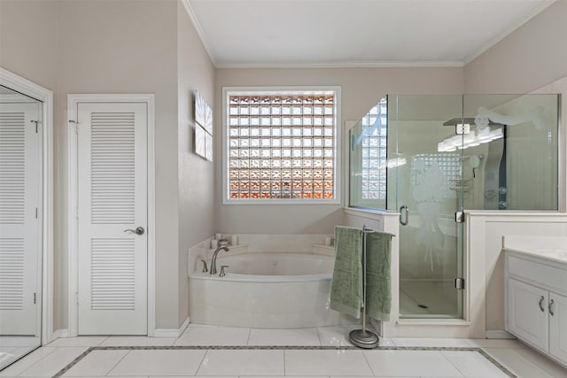 bathroom featuring a closet, a shower stall, vanity, and a garden tub