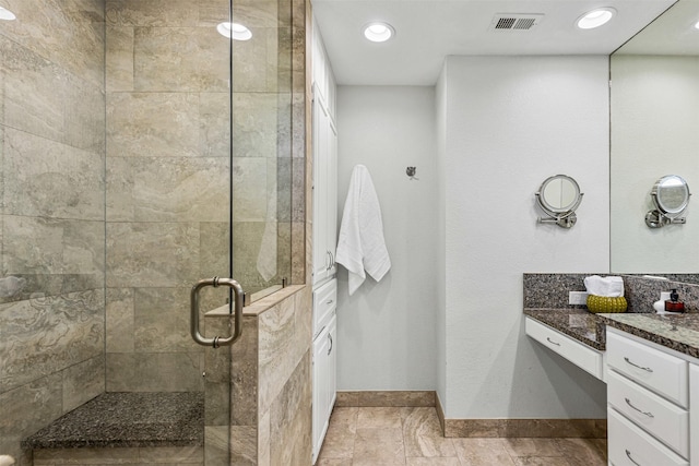 full bath with vanity, visible vents, baseboards, recessed lighting, and a stall shower