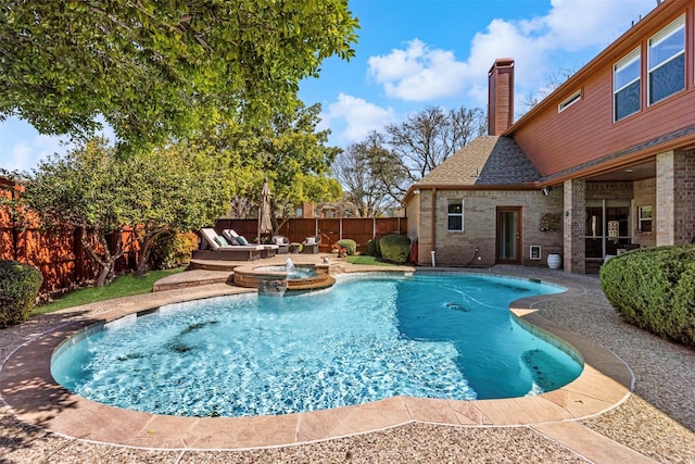 view of swimming pool with a patio area, a fenced backyard, and a pool with connected hot tub