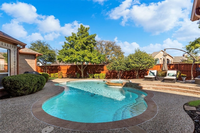 view of swimming pool featuring a patio, a fenced backyard, and a pool with connected hot tub