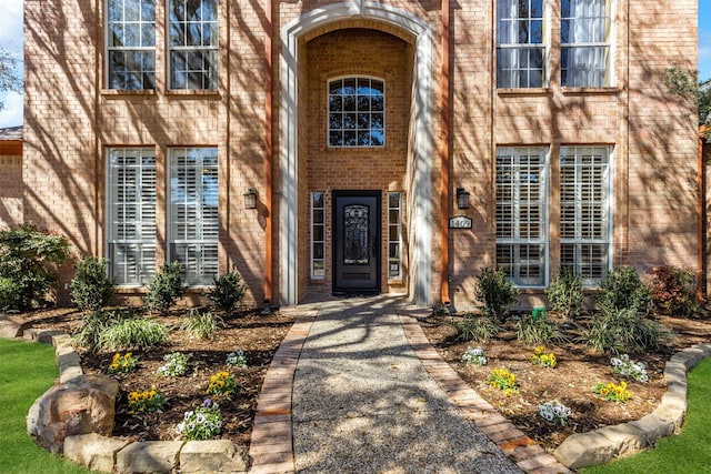 doorway to property with brick siding