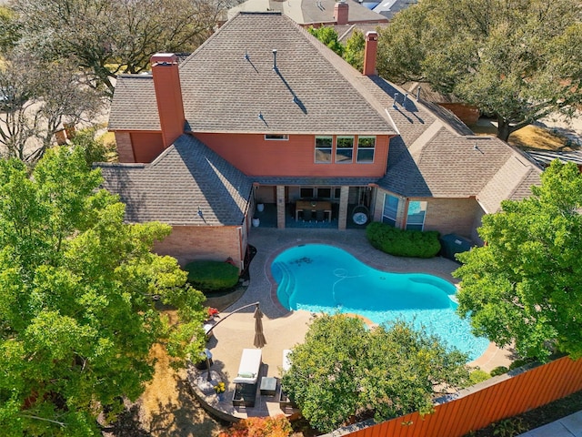 view of swimming pool with a patio and fence