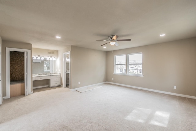 unfurnished bedroom featuring visible vents, baseboards, light carpet, recessed lighting, and ensuite bathroom