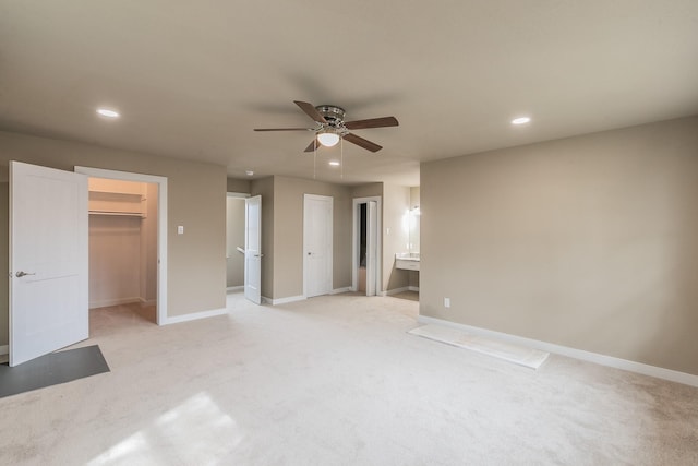 unfurnished bedroom with a ceiling fan, recessed lighting, baseboards, and light carpet