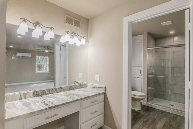 bathroom featuring visible vents, a shower stall, a wall mounted air conditioner, toilet, and wood finished floors