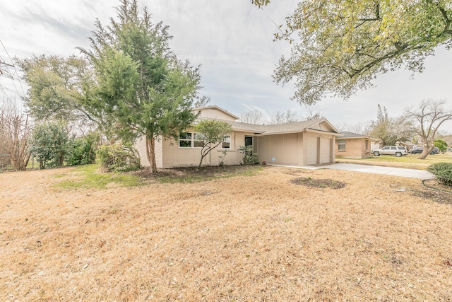 single story home featuring concrete driveway and an attached garage