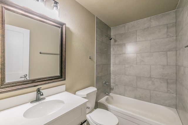 bathroom with toilet, vanity, bathing tub / shower combination, and a textured wall