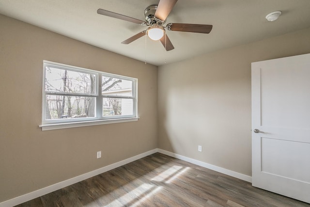 unfurnished room featuring wood finished floors and baseboards