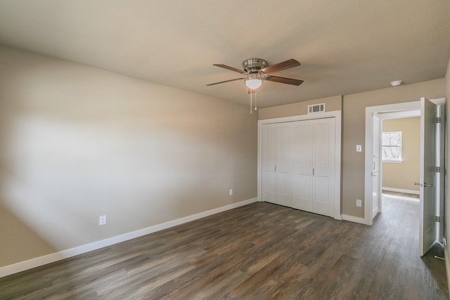 unfurnished bedroom with visible vents, baseboards, a closet, a ceiling fan, and dark wood-style flooring