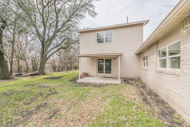 rear view of house featuring a yard and a patio area