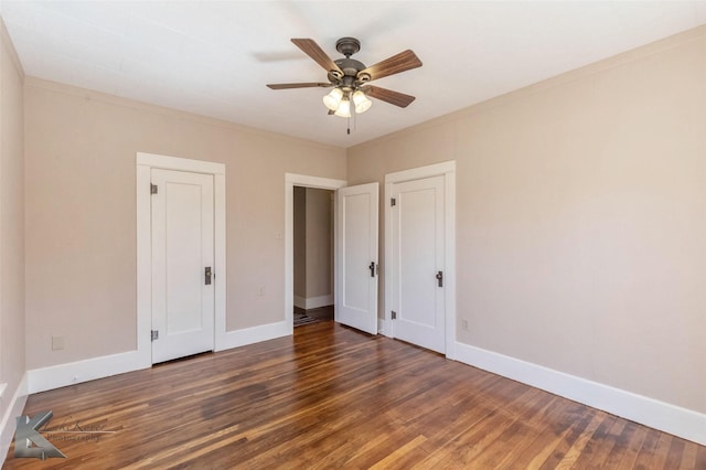 unfurnished bedroom featuring ornamental molding, ceiling fan, baseboards, and wood finished floors