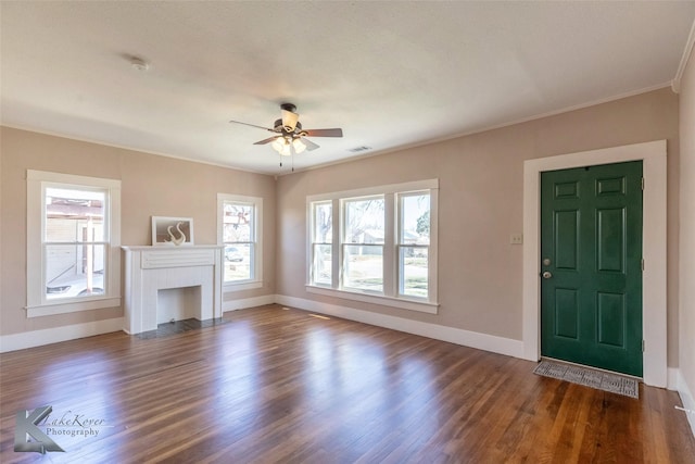 unfurnished living room featuring dark wood-type flooring, a brick fireplace, baseboards, and visible vents