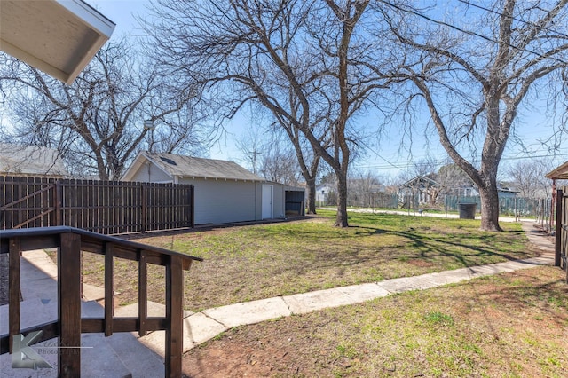 view of yard featuring an outbuilding, a storage shed, and fence