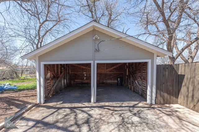 detached garage featuring fence