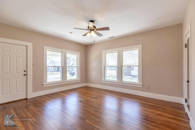 interior space featuring visible vents, baseboards, wood finished floors, and a ceiling fan