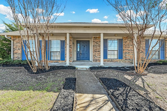 view of front facade featuring a porch and brick siding