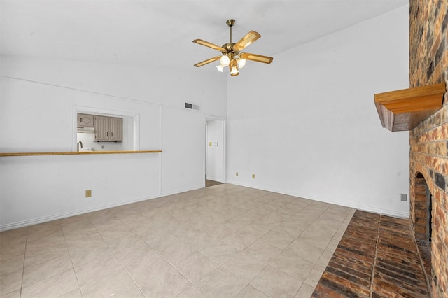 unfurnished living room featuring visible vents, baseboards, ceiling fan, and a fireplace