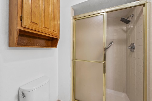 full bathroom featuring toilet and a stall shower