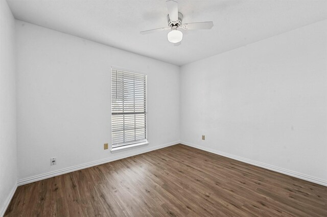 unfurnished room featuring baseboards, wood finished floors, and ceiling fan