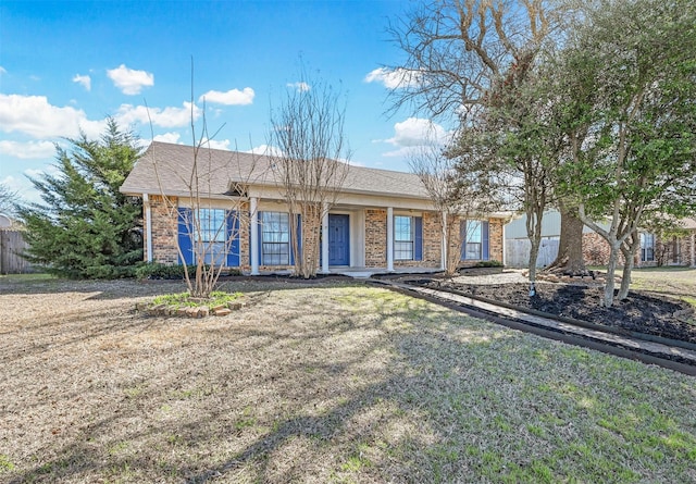 single story home with a front yard and brick siding