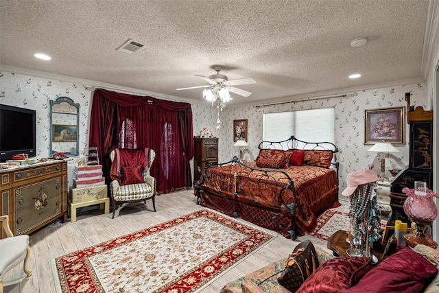 bedroom featuring visible vents, light wood-style flooring, wallpapered walls, and crown molding