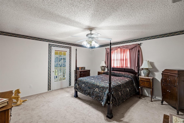 bedroom with a textured ceiling, light colored carpet, and ceiling fan