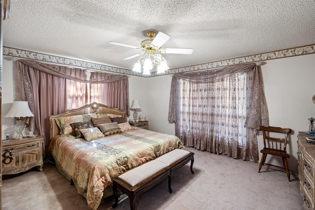 bedroom featuring light carpet, a textured ceiling, and a ceiling fan