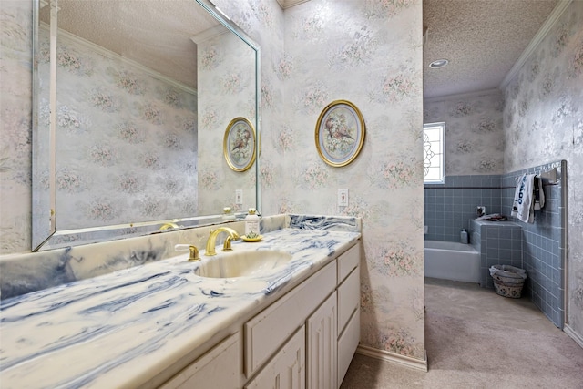 full bath featuring wallpapered walls, vanity, ornamental molding, a bathing tub, and a textured ceiling