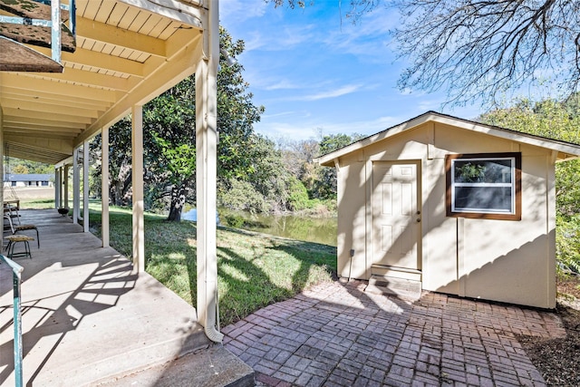 view of patio with an outbuilding