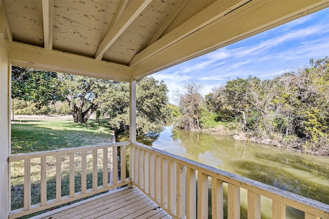 deck featuring a lawn and a water view