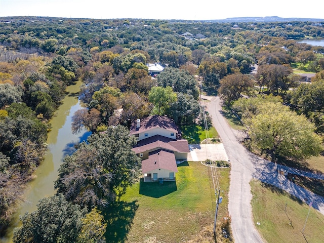 bird's eye view with a wooded view and a water view