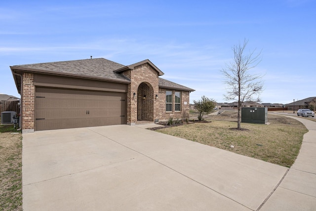 view of front of home with a garage, brick siding, concrete driveway, and a shingled roof