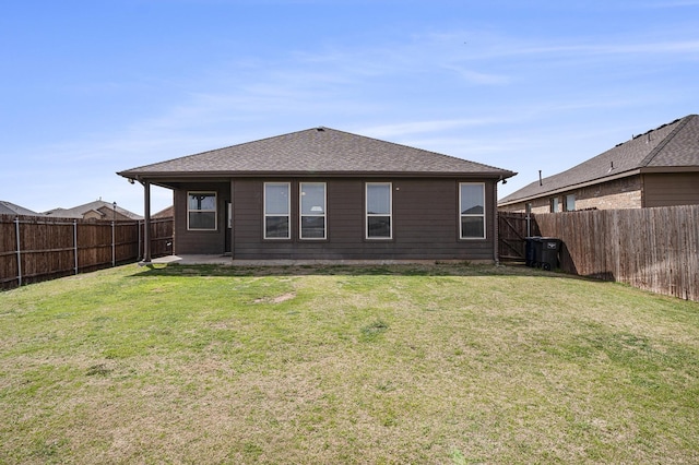 back of house featuring a yard, a patio area, and a fenced backyard