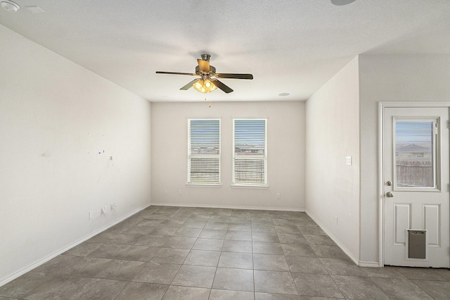 unfurnished room featuring baseboards, a textured ceiling, and ceiling fan