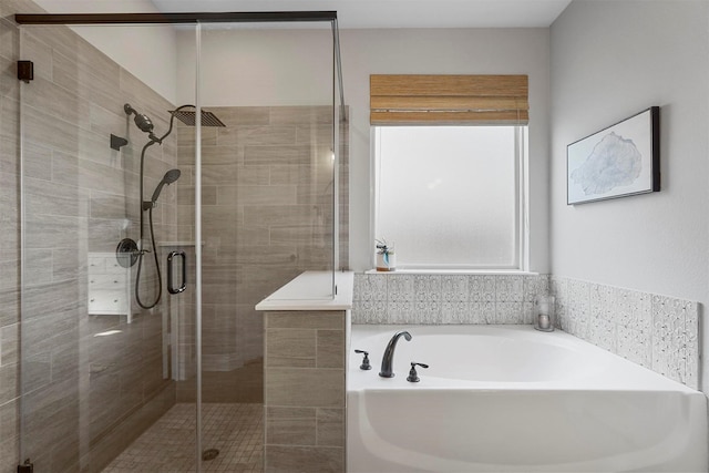 bathroom featuring a bath and a stall shower