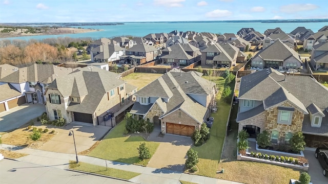 bird's eye view featuring a residential view and a water view