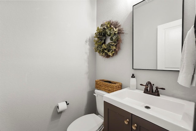 bathroom featuring toilet and vanity