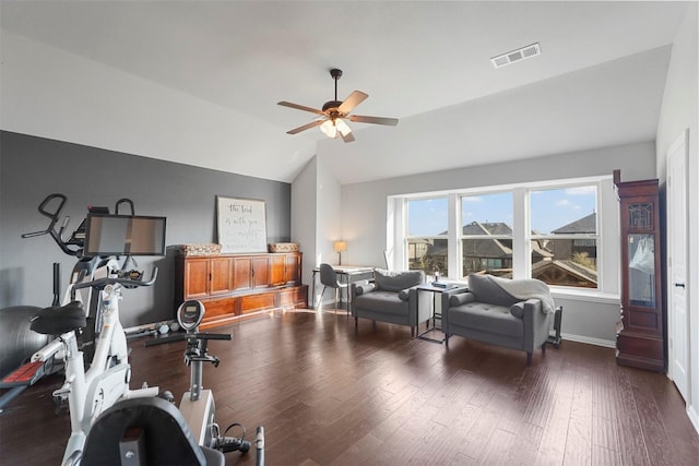 workout area featuring visible vents, baseboards, lofted ceiling, and wood finished floors