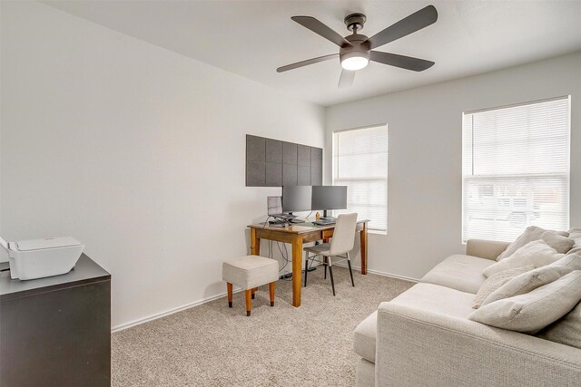 home office with ceiling fan, baseboards, and light carpet