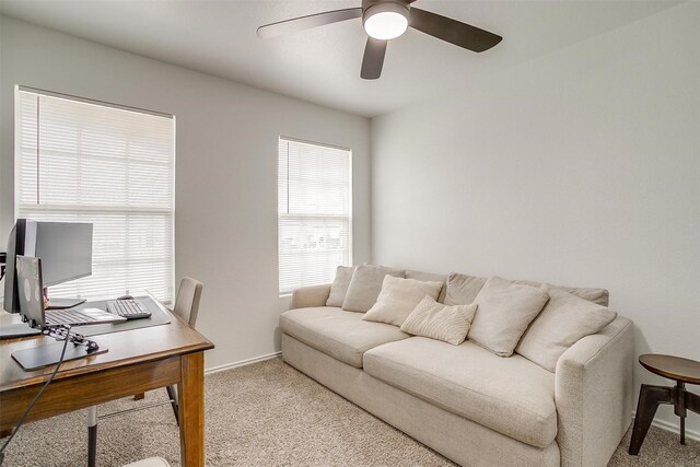 carpeted office space with baseboards and ceiling fan