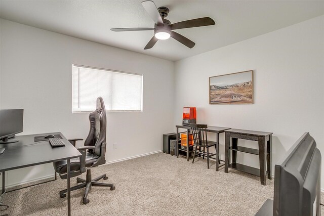 carpeted office featuring baseboards and ceiling fan