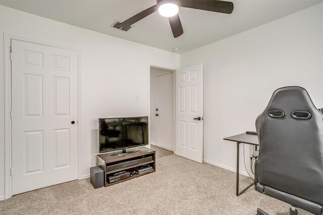 office area with carpet flooring, a ceiling fan, and visible vents