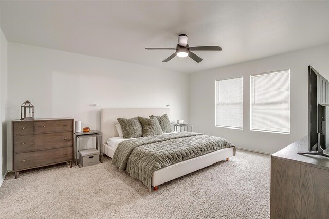 bedroom with light carpet and a ceiling fan