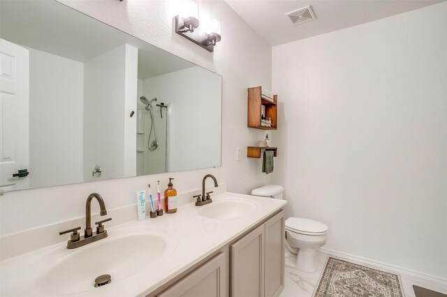 bathroom with visible vents, toilet, a shower, and a sink