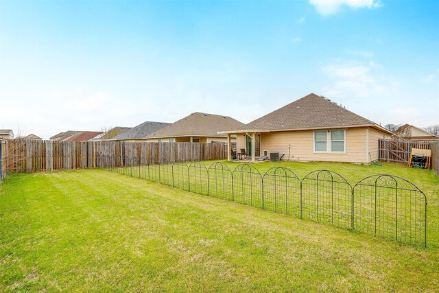 view of yard with a fenced backyard