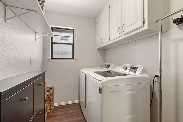 laundry area featuring baseboards, cabinet space, dark wood-style flooring, and washer and clothes dryer